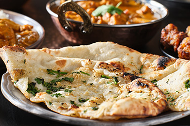 Order a tasty garlic nan from The Gulshan Brasserie